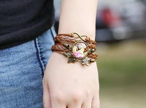 Close-up of retro layered leather bracelet with infinity symbol and butterfly charms