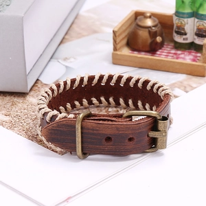 Handmade vintage brown leather bracelet with cross stitching and adjustable bronze buckle