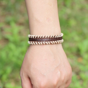Men's vintage dark brown leather bracelet with cream stitching and hand-woven texture