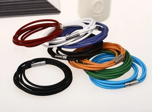 Close-up of multi-layer leather bracelets with sleek silver magnetic metal clasps
