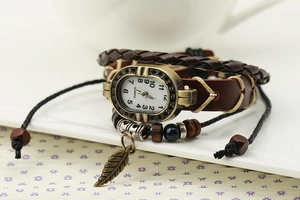 Detail view of vintage leaf leather watch with braided strap and bronze dial elements