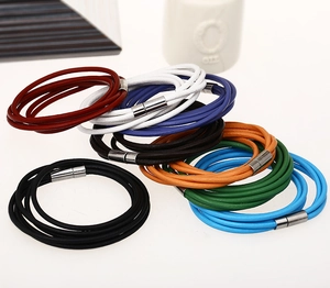 Close-up of multi-layer leather bracelets in various colors with magnetic metal clasps