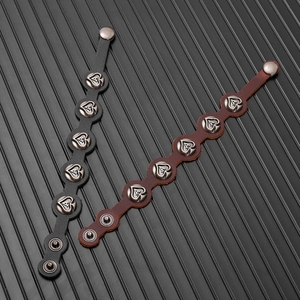 Detail of vintage leather bracelets with five metallic studs featuring ace heart engraving