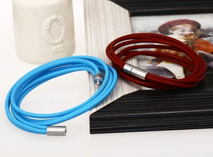 Close-up of double-loop genuine leather bracelets with magnetic clasps in blue and red