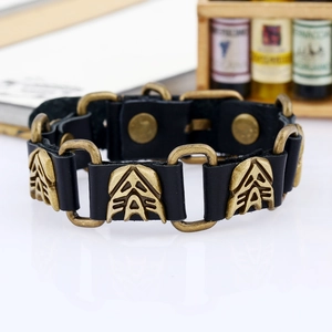 Detail of punk leather bracelet with bronze metal plates and snap button closure