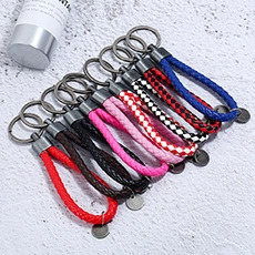 Macro detail of assorted woven leather keychains in vibrant colors with gunmetal rings