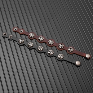 Detail view of leather bracelets with silver metal spade studs in black and brown colors