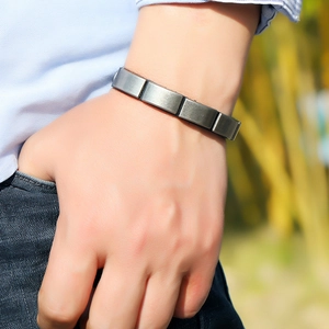 Detail of dark silver brushed metal links on a men's punk style stainless steel bracelet