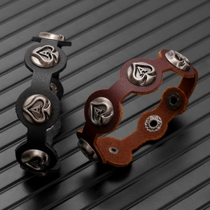 Detail of vintage leather bracelets with spade heart rivets and adjustable metal snaps