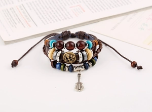Detail of bohemian multilayer leather bracelet with bronze guitar charm and colorful beads