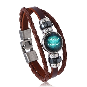 Detailed close-up of braided leather zodiac bracelet featuring an Aquarius symbol pendant