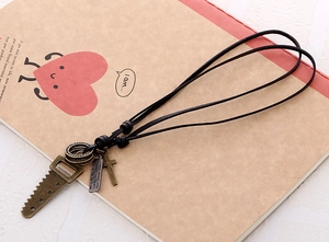 Detail of vintage bronze tool pendants on double black leather cord necklace