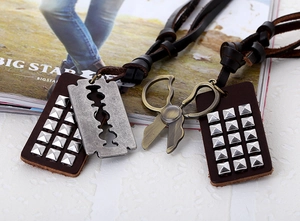 Detail of vintage punk leather necklace featuring razor blade and scissor metal pendants