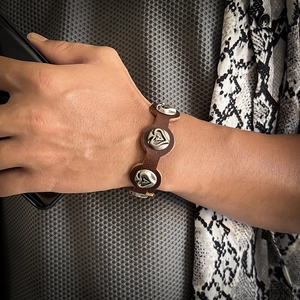 Vintage brown leather bracelet with silver heart-shaped metal buckles and cutout charms