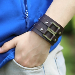 Men's punk style wide brown leather bracelet featuring silver metal buckles and rivets