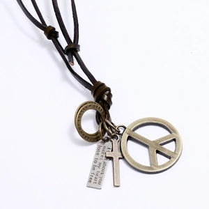 Detail of peace sign and cross pendants on an adjustable brown leather cord necklace