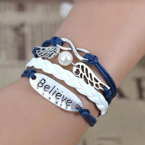 Woven multilayer bracelet with wings pendant and Believe engraved metal plate