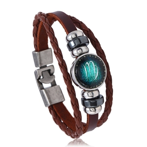 Detailed view of handmade multilayer brown leather bracelet with Virgo zodiac charm