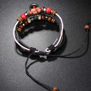 Detail of multilayer beaded leather bracelet with vintage wooden beads and pull-string