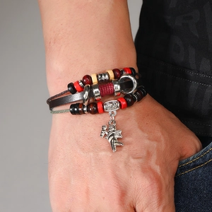 Close-up of beaded leather bracelet with angel pendant and wooden beads on wrist