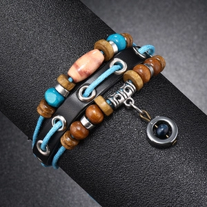Detail of bohemian multilayer leather bracelet featuring blue beads and wood accents