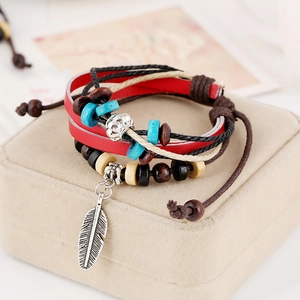 Multilayer beaded leather bracelet with a silver feather charm and vintage wood beads