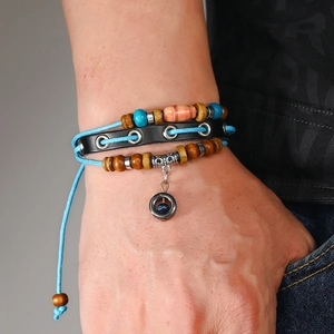 Close-up of multilayer leather beaded bracelet with wood beads and metal ring charm