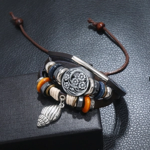 Retro multi-layer leather bracelet with beaded shells and floral metal charms on a gift box