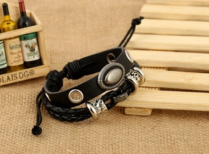 Detail of vintage multilayer black leather bracelet with metal rivets and floral beads