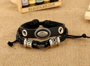 Close-up of vintage punk leather bracelet set with metallic studs and silver beads