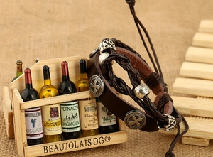 Macro shot of vintage multilayer brown leather bracelet featuring cross relief charms