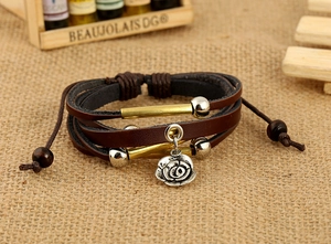 Detailed close-up of a vintage leather layered bracelet with a silver rose flower charm