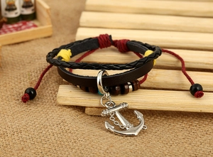 Detail view of handmade layered leather bracelet with silver anchor and wooden beads
