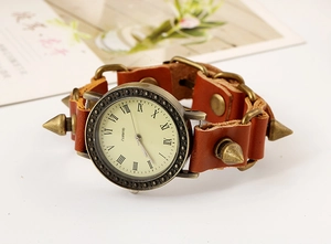 Close-up of vintage punk leather watch featuring bronze cone spikes and Roman numerals