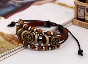 Detail of multi-layer leather bracelet with wooden beads and iron cross metal rings