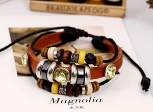 Detailed close-up of layered leather bracelet with wooden beads and sparkling crystals