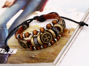 Detail of multi-layer leather bracelet featuring wooden beads and iron cross charms
