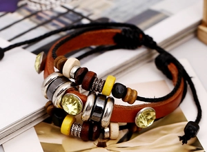 Macro shot of punk leather bracelet with multicolored beads and faceted yellow crystals