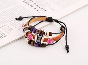 Detail of multi-layer leather bracelet with pink rhinestones and vintage wooden beads