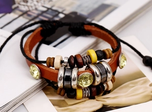 Detailed view of multilayer leather bracelet with yellow beads and bohemian braided ropes
