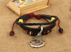 Detailed shot of multi-layer leather bracelet featuring a vintage silver anchor pendant