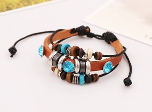 Detail of bohemian multilayer leather bracelet featuring blue rhinestones and wooden beads