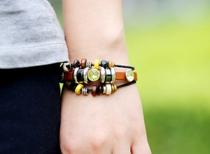 Close-up of bohemian multilayer leather bracelet with wooden beads and faceted crystals