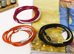 Detailed view of multi-wrap leather cord bracelets with metallic magnetic clasps