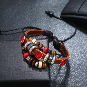 Detailed shot of multi-layer bohemian leather bracelet with wooden beads and red crystals