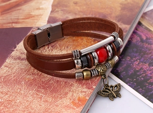 Macro view of multilayer leather bracelet with bronze butterfly charm and stainless buckle