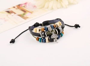 Detailed close-up of a multi-layer leather bracelet with beads and silver umbrella charm
