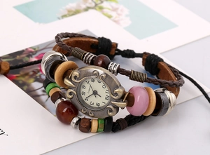 Macro view of vintage bohemian leather bracelet watch with colorful beads and bronze case