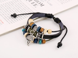 Detail of multilayer vintage leather bracelet featuring colorful wood beads and silver umbrella charm