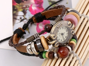Detail of vintage multilayer leather bracelet watch with wooden beads and bronze dial